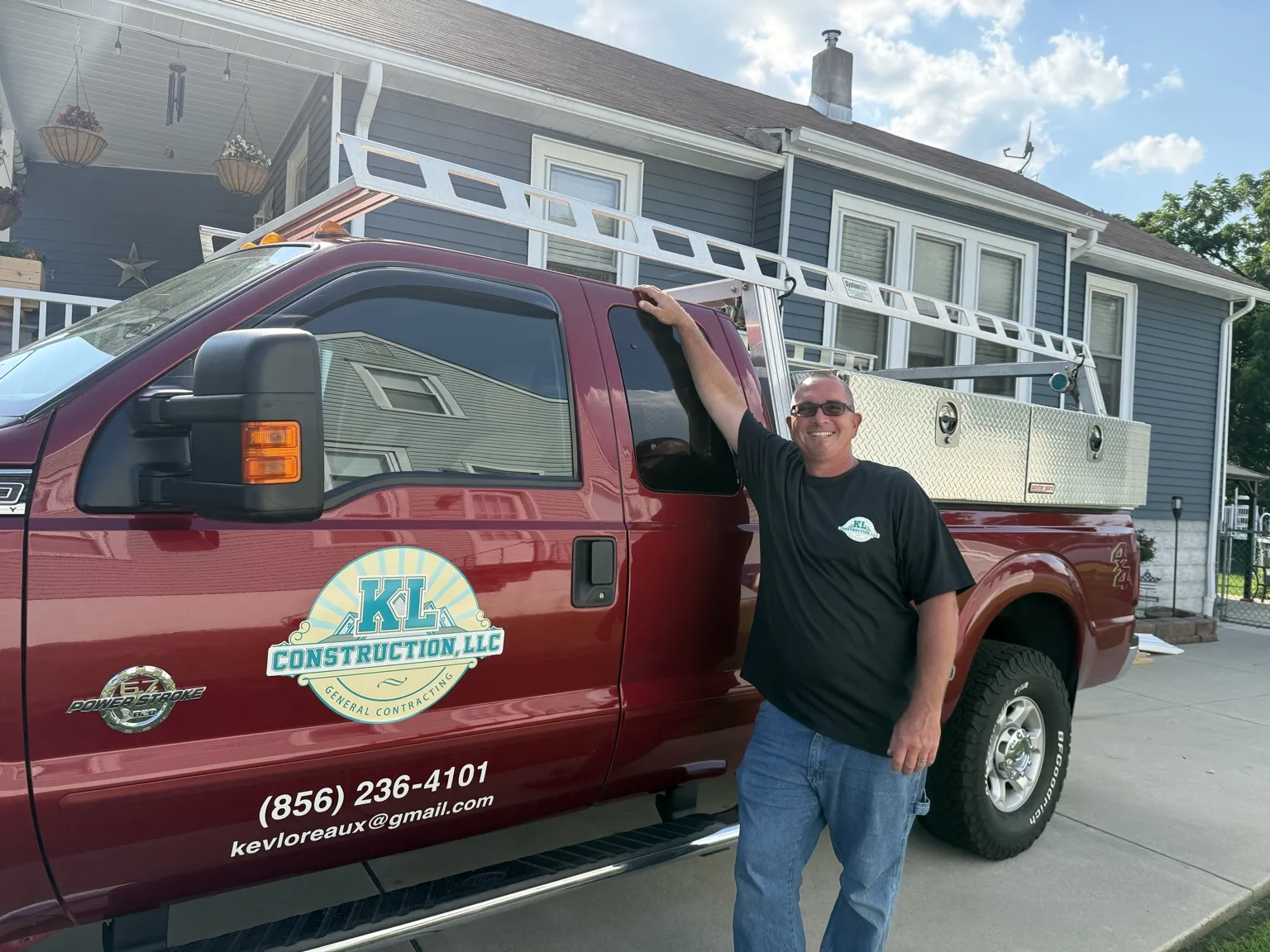 Kevin Loreaux standing beside the KL Construction work truck