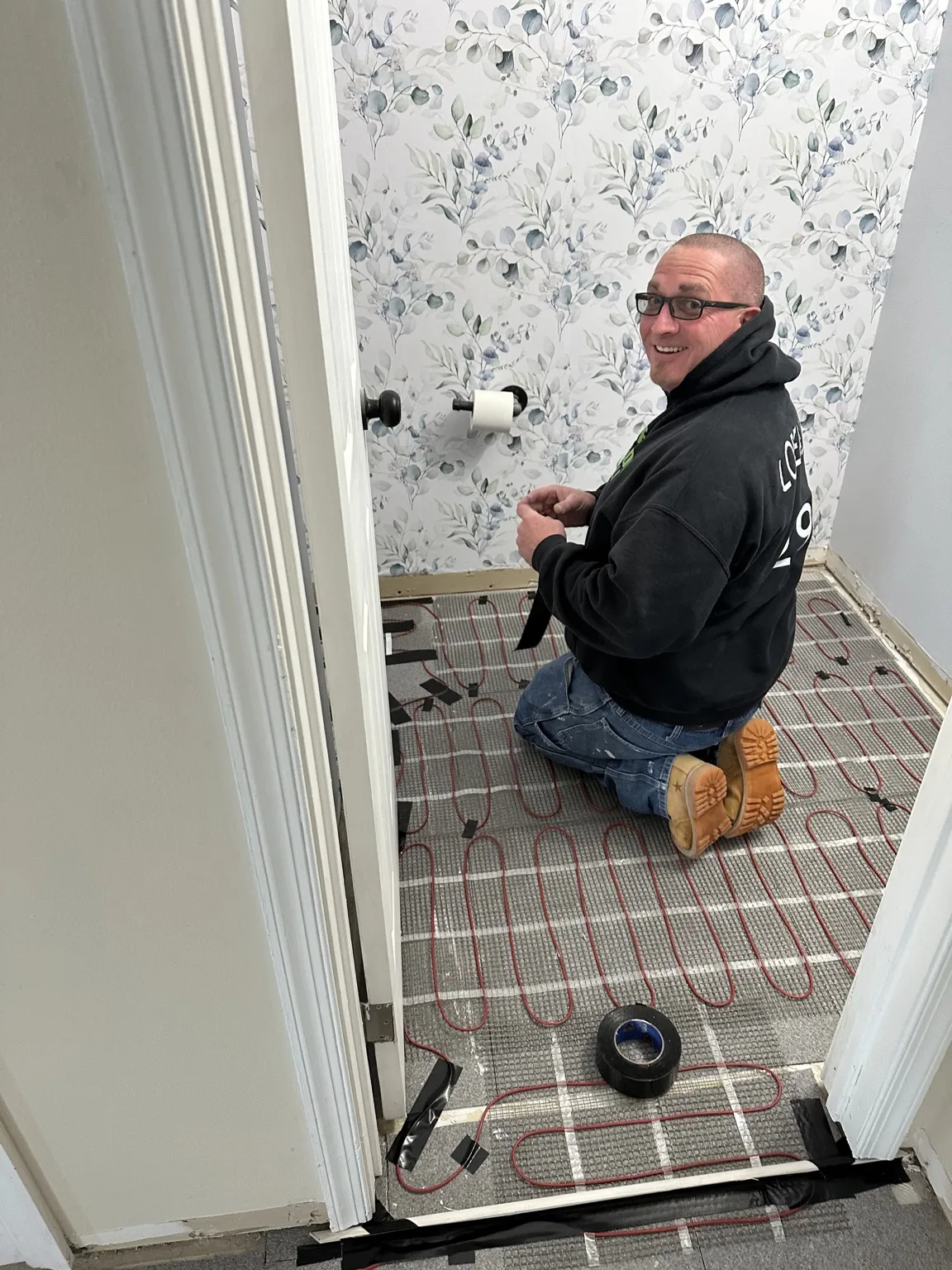 Kevin Loreaux installing a heated bathroom floor