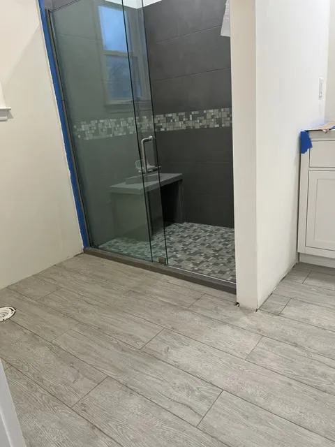Finished bathroom flooring and glass shower